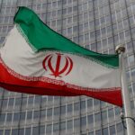 file photo: an iranian flag flutters in front of the iaea headquarters in vienna