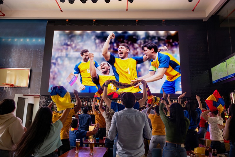 colombian football fans at a bar celebrating a victory from their team